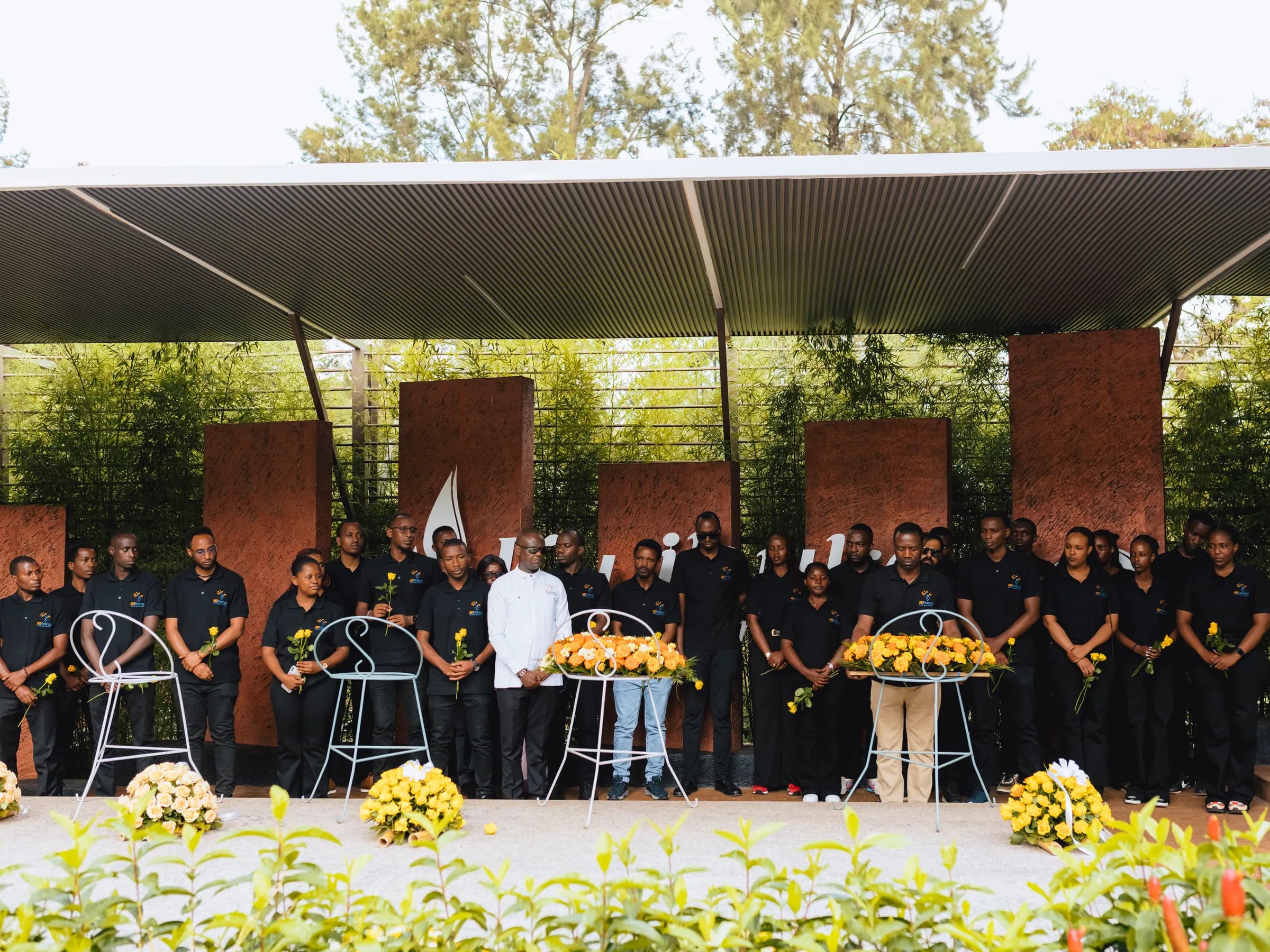 The whole team standing in remembrance at the mass graves